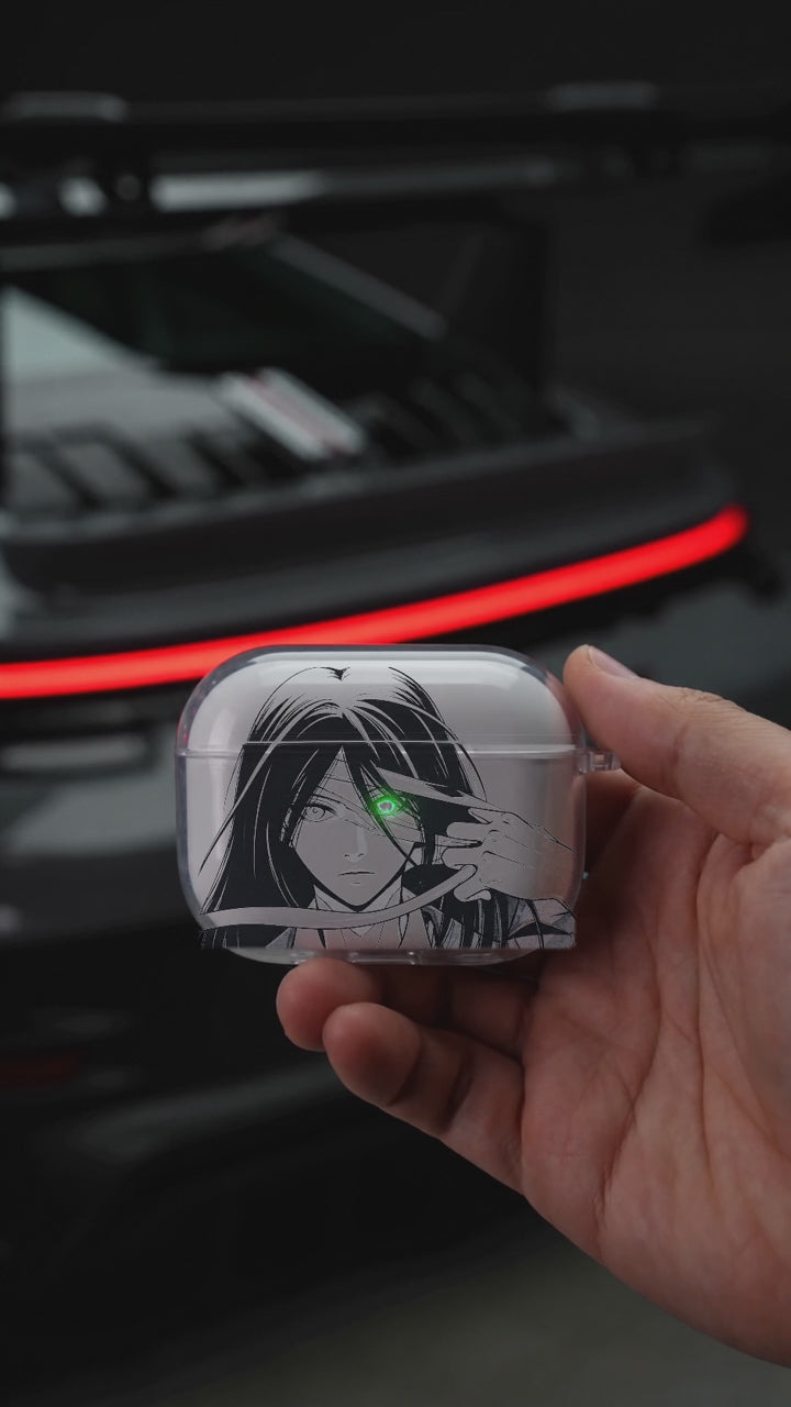Mikasa Eye AirPods case opening in hand with Porsche background