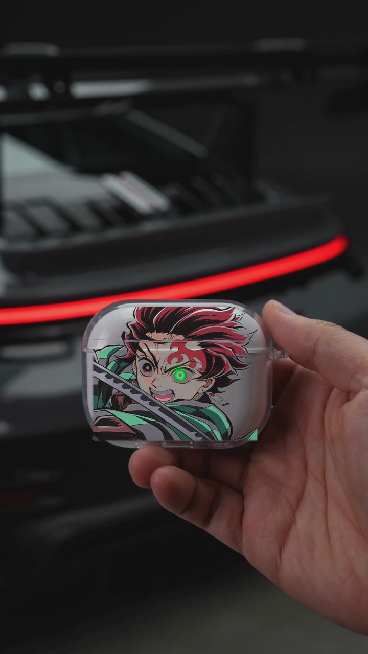 Tanjiro Blade AirPods case opening in hand with Porsche background
