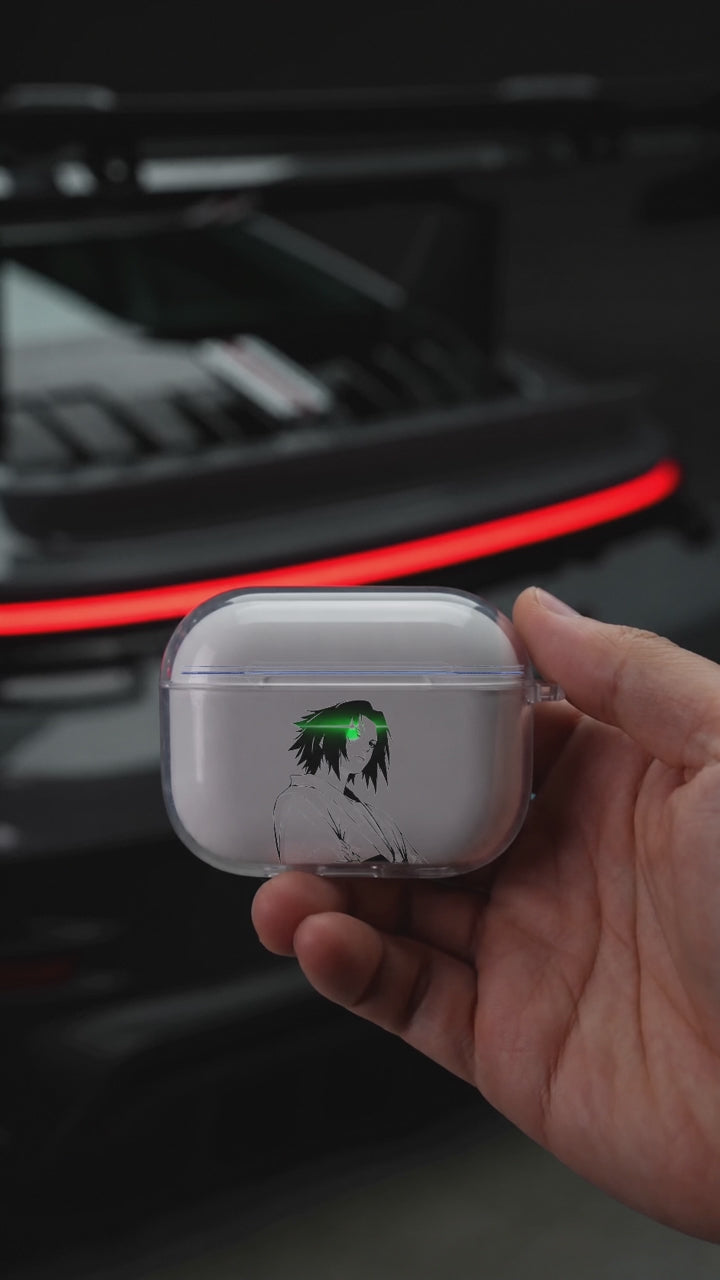 Sasuke Seated AirPods case opening in hand with Porsche background