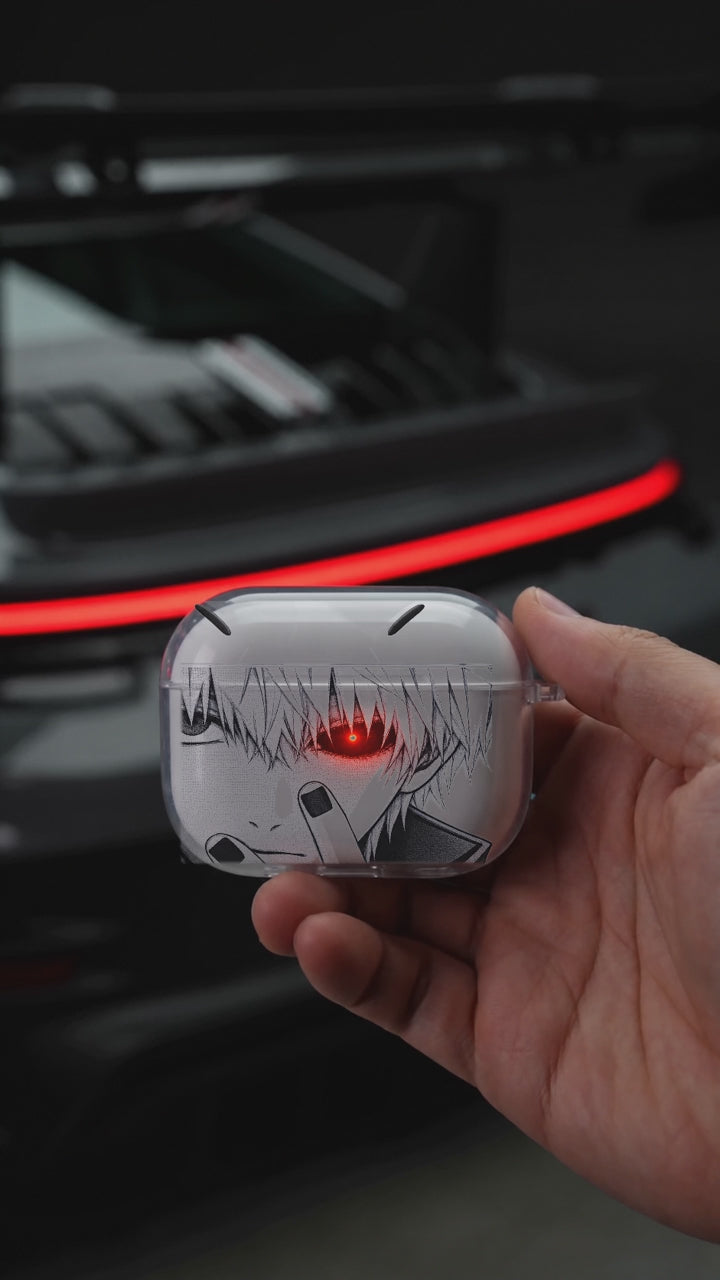 Gojo Red Eye AirPods case opening in hand with Porsche background