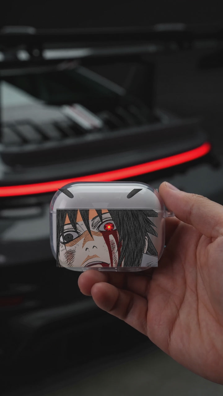 Madara Fallen AirPods case opening in hand with Porsche background