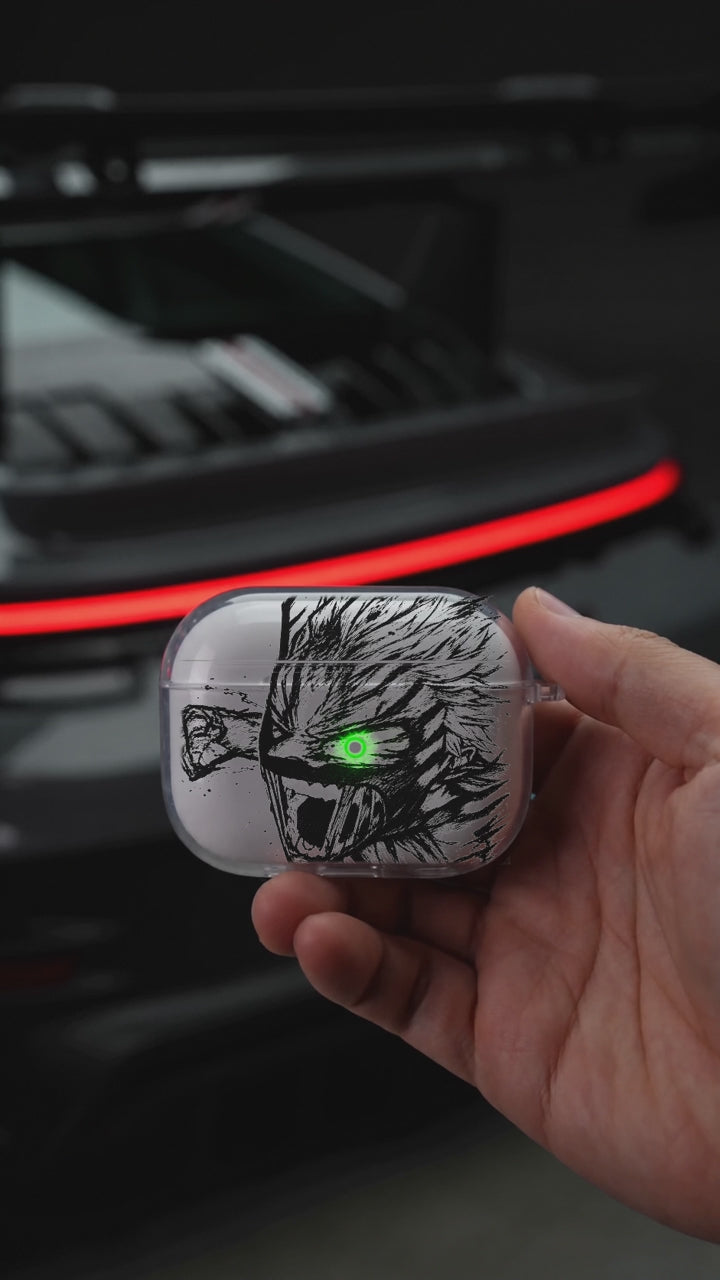 Monster Eye AirPods case opening in hand with Porsche background