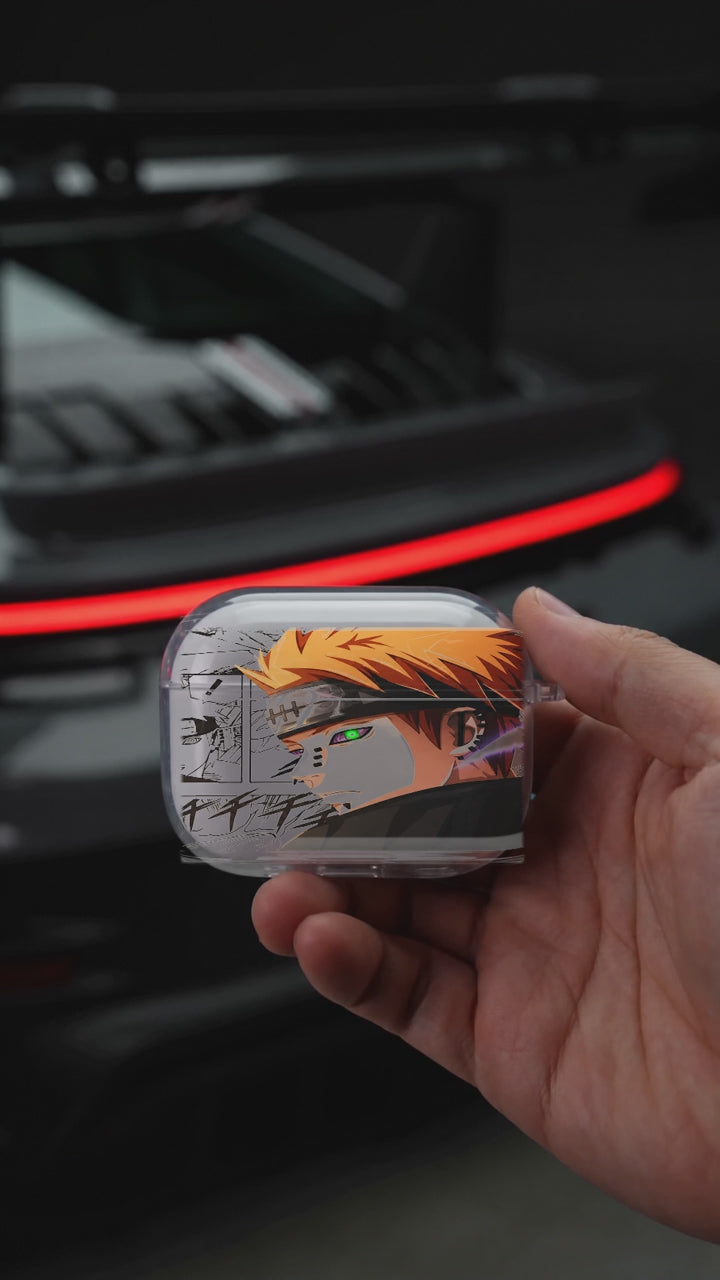 Pain Manga AirPods case opening in hand with Porsche background